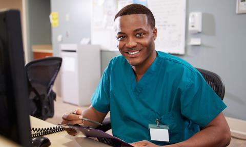 nurse at desk in office